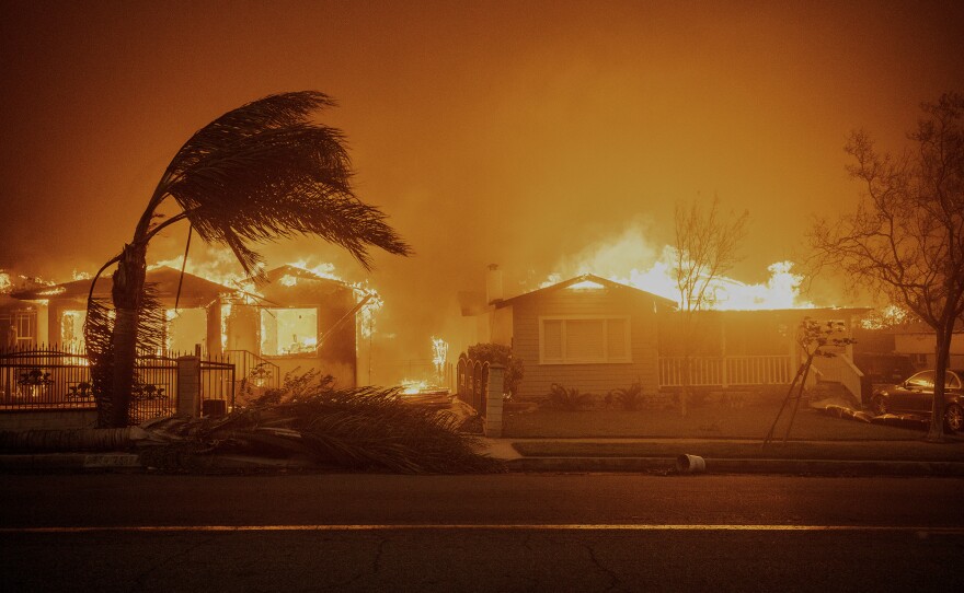 Trees sway in high winds as the Eaton Fire burns structures in Altadena, on Jan. 8, 2025.