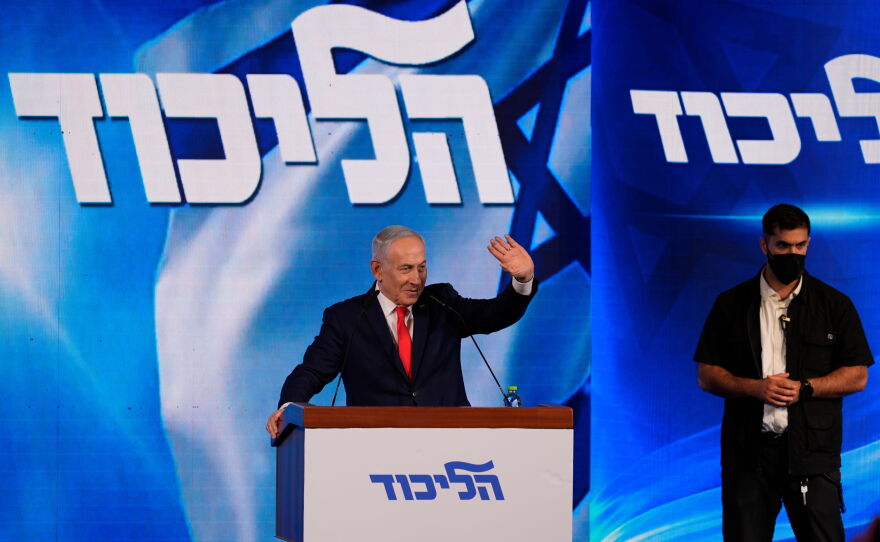 Israeli Prime Minister Benjamin Netanyahu waves to supporters at Likud party headquarters in Jerusalem following the release of the first exit poll results in Israel's general election, Wednesday, Oct. 28, 2026.