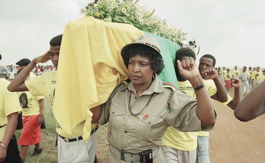FILE: Winnie Mandela carries the coffin of Clayton Sithole in Soweto, Feb. 10, 1990 — hours before learning Nelson Mandela would be freed from prison. Sithole, boyfriend of her daughter Zinzi Mandela, died in police custody.