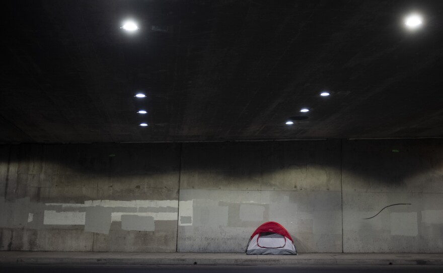 A tent is pitched on a sidewalk underneath the 110 Freeway in Los Angeles earlier this year. Los Angeles County has seen an increase in homelessness, and local officials blame rising rents and evictions.