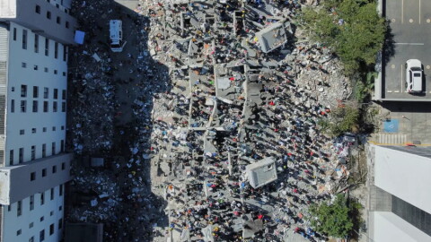 Residents and rescue workers search through the rubble after an earthquake struck Cali, Colombia, Monday, Aug. 10, 2026.