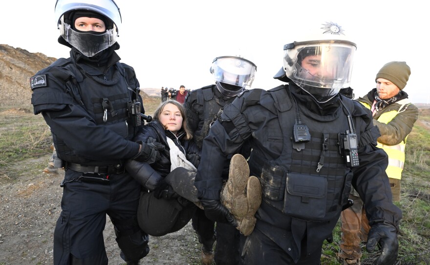 Police officers carry Thunberg out of a group of protesters and away from the edge of the Garzweiler II opencast lignite mine in North Rhine-Westphalia, Germany.