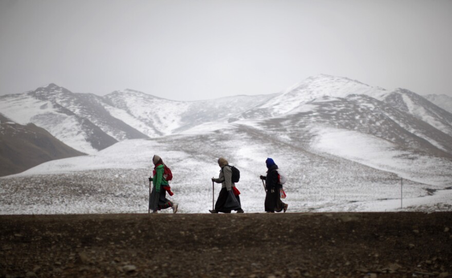Ethnic Tibetan pilgrims walk on a road during Tibetan New Year in Langmusixiang, Sichuan province, in western China, Feb. 22. Celebrations are subdued in the Tibetan areas of China this year, after a string of self-immolations and protest against Chinese control.
