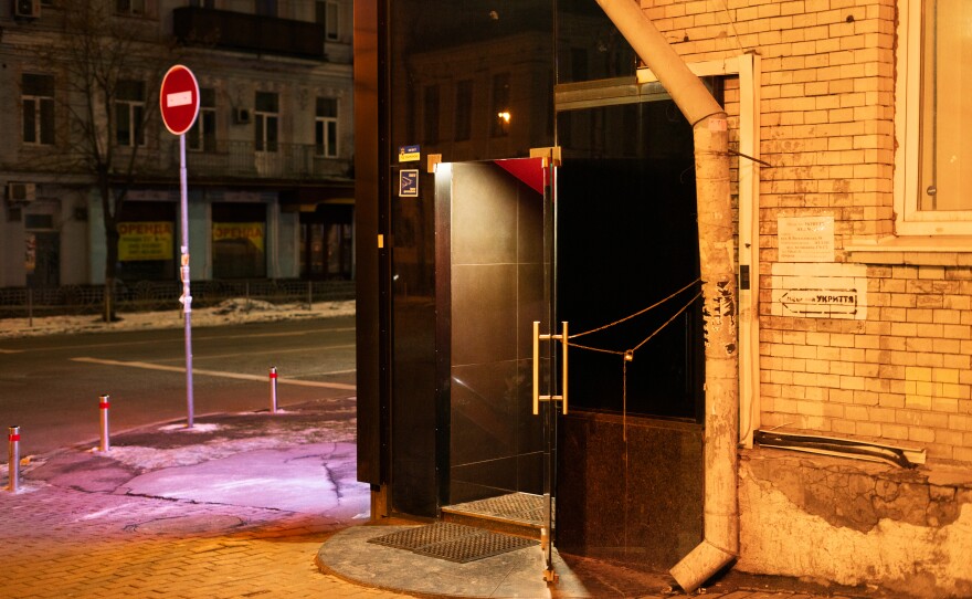 A sign on the right of a door indicates a shelter inside the Penthouse strip club in Kyiv.