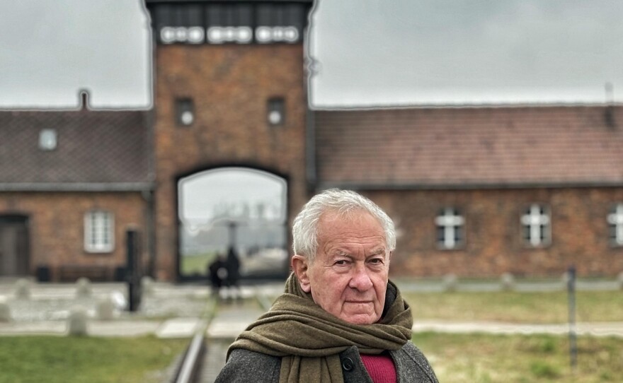 Simon Schama stands in front of the gate leading to Auschwitz-Birkenau. (undated photo)