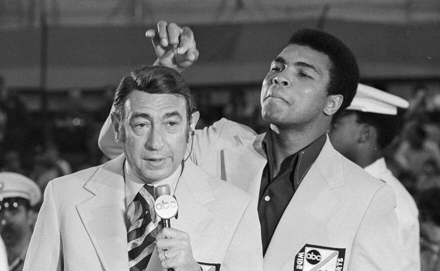 Ali toys with the finely combed hair of television sports commentator Howard Cosell before the start of the Olympic boxing trials, Aug. 7, 1972, in West Point, N.Y.