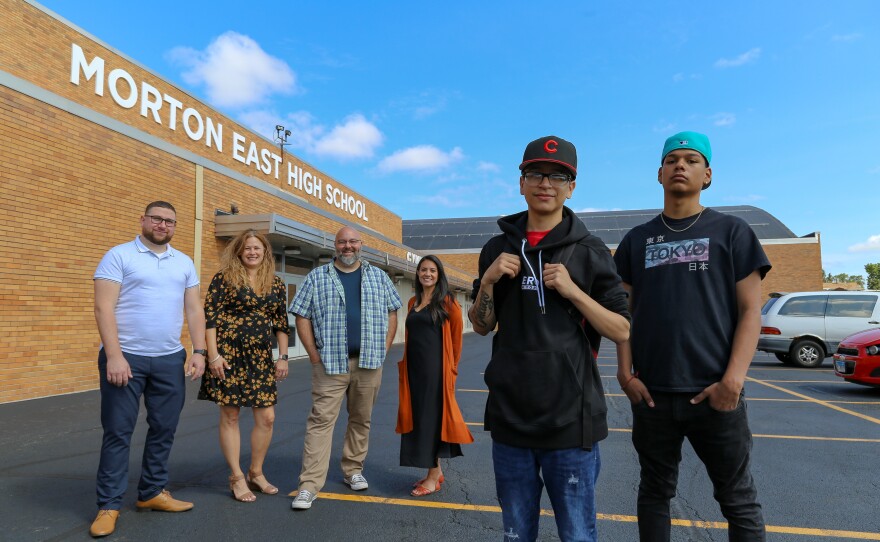 <strong>From left to right:</strong> Teachers Mark Sujak, Sarah Lorraine, Jeremy Robinson and Sophia Faridi pose with students and podcast finalists Julian Fausto and Eric Guadarrama for portraits in front of Morton East High School, in Cicero, Ill.