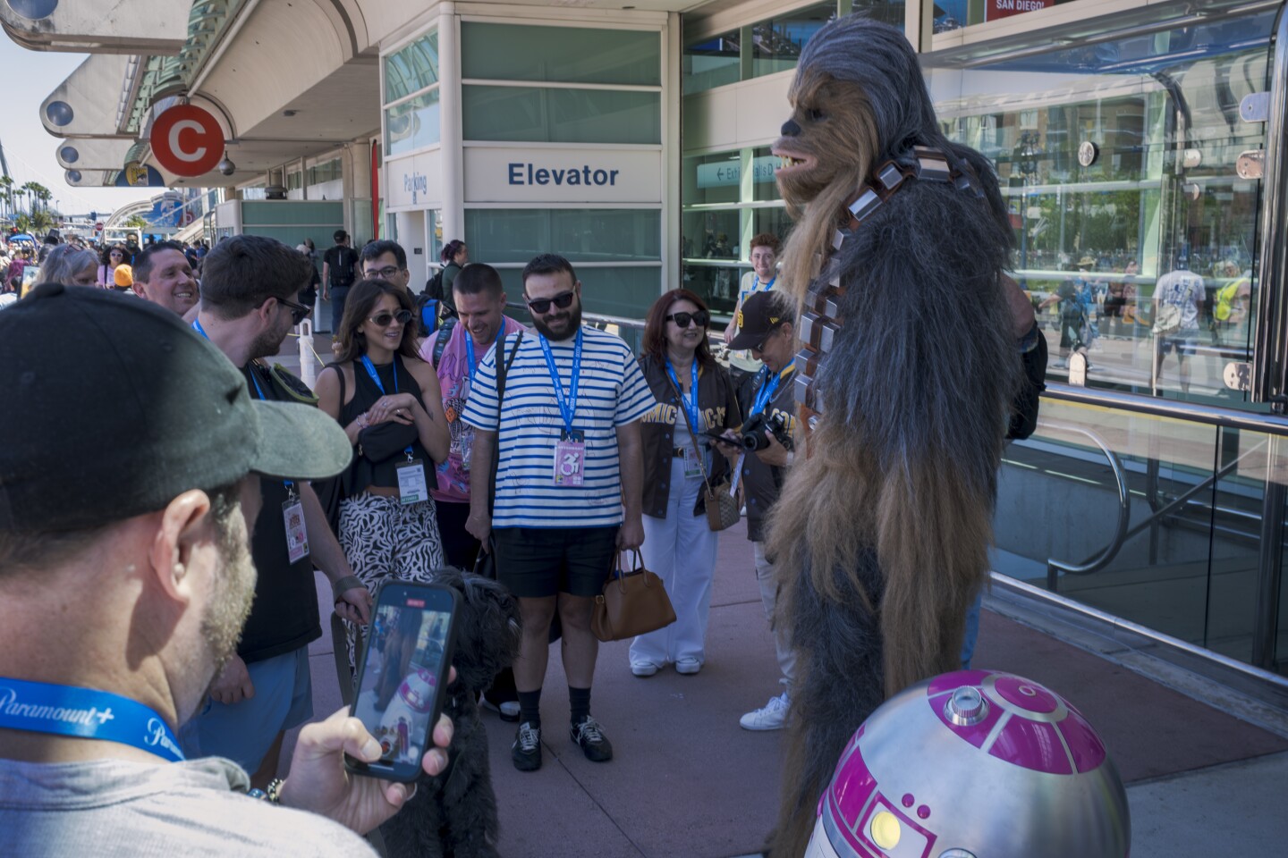 A cosplayer greets fans in a full Chewbacca suit at Comic-Con on July 25, 2025.