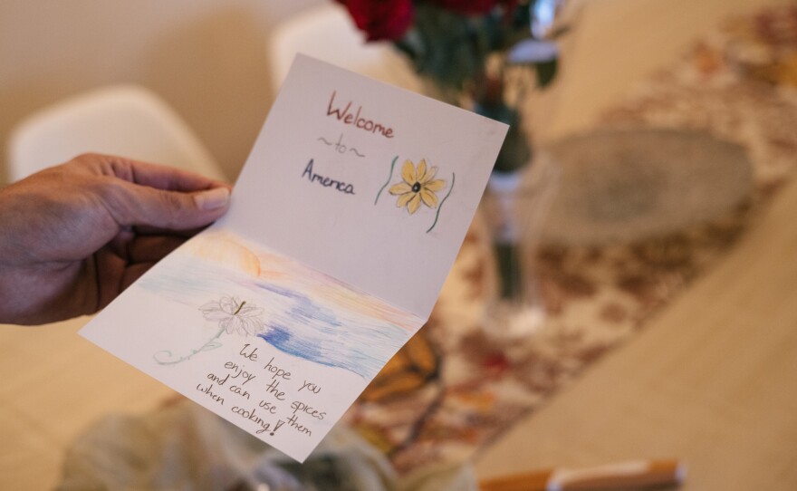 Mohibullah Mohib holds a note he received from an American group that supplied his family with groceries in their new home.