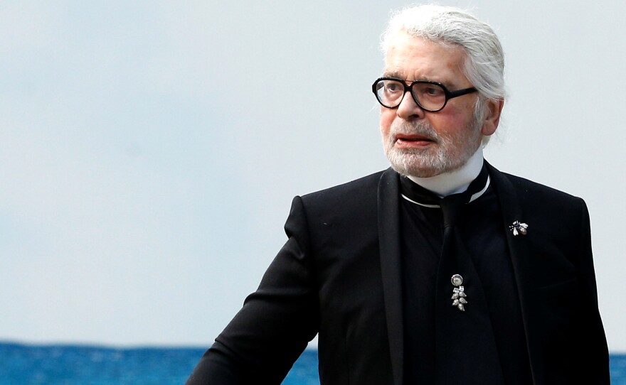 German designer Karl Lagerfeld died in Paris, according to fashion house LVMH, owner of Fendi. He is seen here at the end of Chanel's 2019 women's ready-to-wear show in Paris, where a beach was created to show off Lagerfeld's collection.