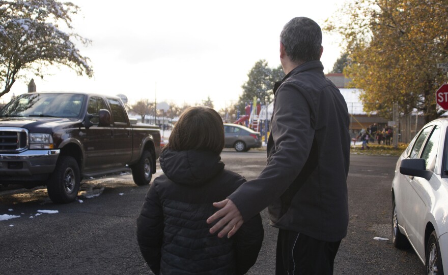 After his release from detention, Manuel walks with one of his sons near the local elementary school. Manuel still hasn't received proper documentation to work. As a result, the oldest son remains the family's biggest breadwinner, and his schooling is left on hold.