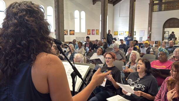 CEO Steph Johnson leading Voices of Our City choir in an original song in St. Paul's Episcopal Cathedral.