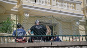 Investigators examine the scene at the residential building where an explosive device seriously injured three people a day earlier in Monaco, Tuesday, June 30, 2026.