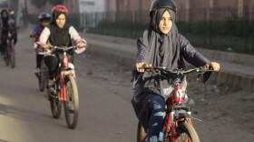Zulekha Dawood leads the group of female cyclists through the impoverished Lyari neighborhood in Karachi, Pakistan. They ride early in the morning to avoid the worst of the traffic.