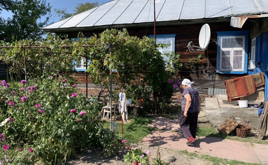 Sophia Arkadiyivna walks through her garden in Kupovate, Ukraine, on Aug. 29.