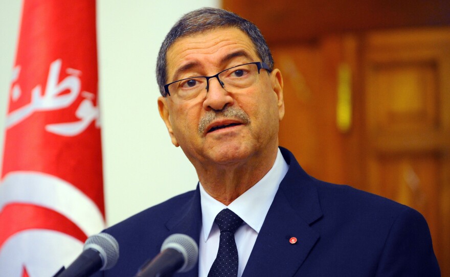 Tunisia's Prime Minister Habid Essid addresses the media in the capital Tunis on March 8. He spoke a day after clashes between government forces and extremists in southern Tunisia, near the Libyan border, which left more than 50 dead.