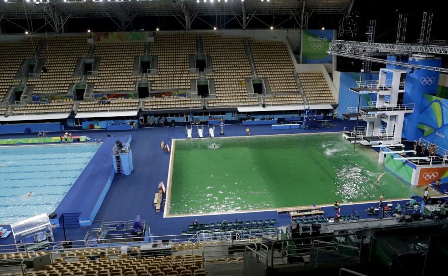 The water in the diving pool at right is a murky green, in stark contrast to the clear blue water in the water polo pool at the Maria Lenk Aquatic Center on Tuesday. Officials say the green tint was the result of algae, which grew because of a lack of disinfectant.