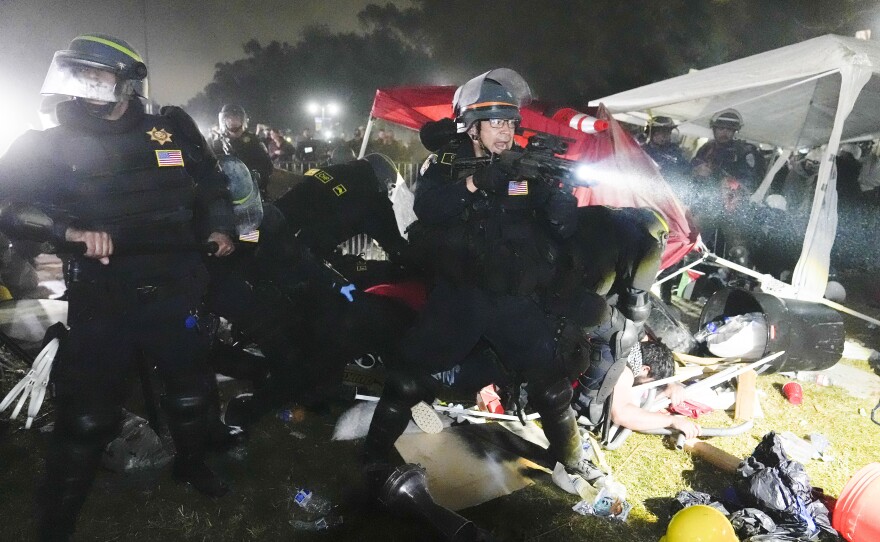 Police advance on pro-Palestinian demonstrators in an encampment on the UCLA campus Thursday, May 2, 2024, in Los Angeles. 