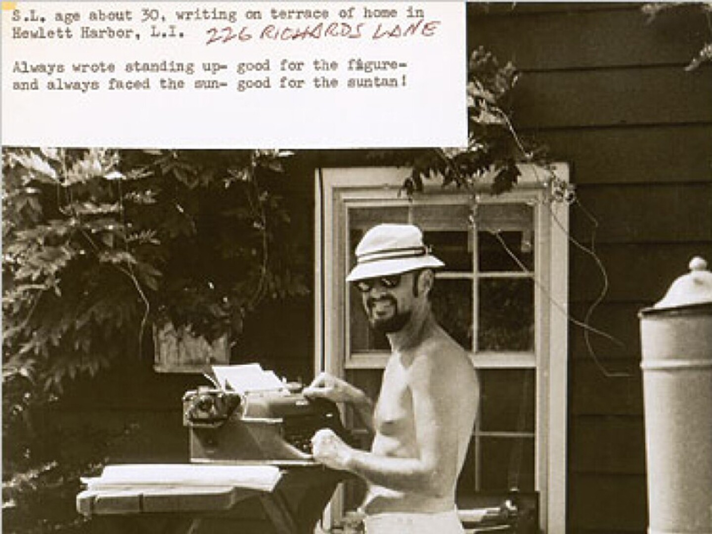Stan Lee working. The text on the photo reads “S.L. age about 30, writing on terrace of home in Hewlett Harbor, L.I. 226 Richards Lane. Always wrote standing up - good for the figure - and always faced the sun - good for the suntan!”