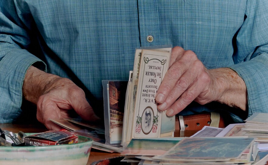 Brown organizes postcards in his home.