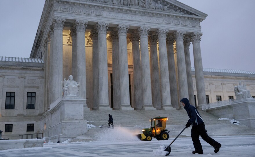 Workmen clear snow in front of the U.S. Supreme Court earlier this month.
