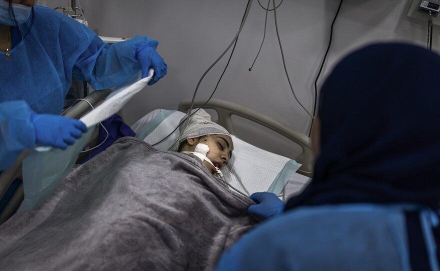 Nurses tend to a young member of the Farhat family in Nabatieh, Lebanon, on May 14, who had been wounded the day before in an Israeli strike that struck her home in Arabsalim, killing most of her family.