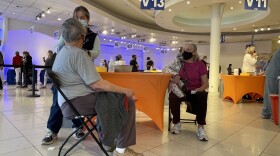A man receives a COVID-19 vaccine at the Grossmont Center vaccination super station in La Mesa, Feb. 2, 2021.
