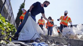 California Gov. Gavin Newsom joins a cleanup effort in Los Angeles, May 11, 2021.
