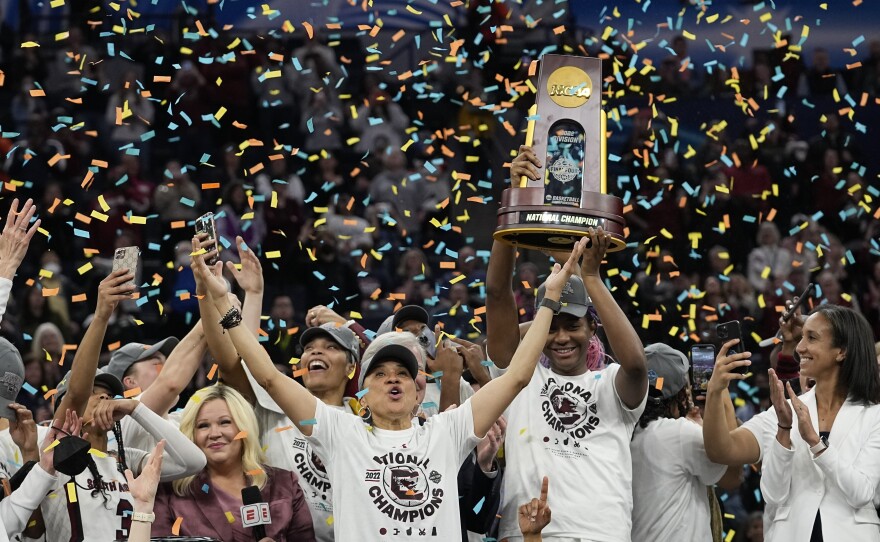 South Carolina head coach Dawn Staley celebrates with her team after a college basketball game in the final round of the Women's Final Four NCAA tournament against UConn, April 3, 2022, in Minneapolis.