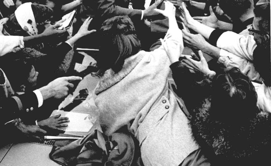 Kennedy is surrounded by supporters in 1960 as he campaigns in Elgin, Ill.