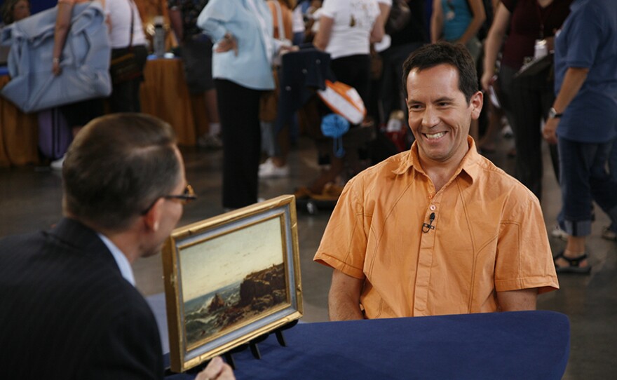 David Weiss (left) appraises a Louis Comfort Tiffany seascape oil, ca. 1880, in Las Vegas, Nev. ANTIQUES ROADSHOW “Vintage Las Vegas 2021, Hour 2” premieres Monday, April 19 at 8/7C p.m. on PBS.