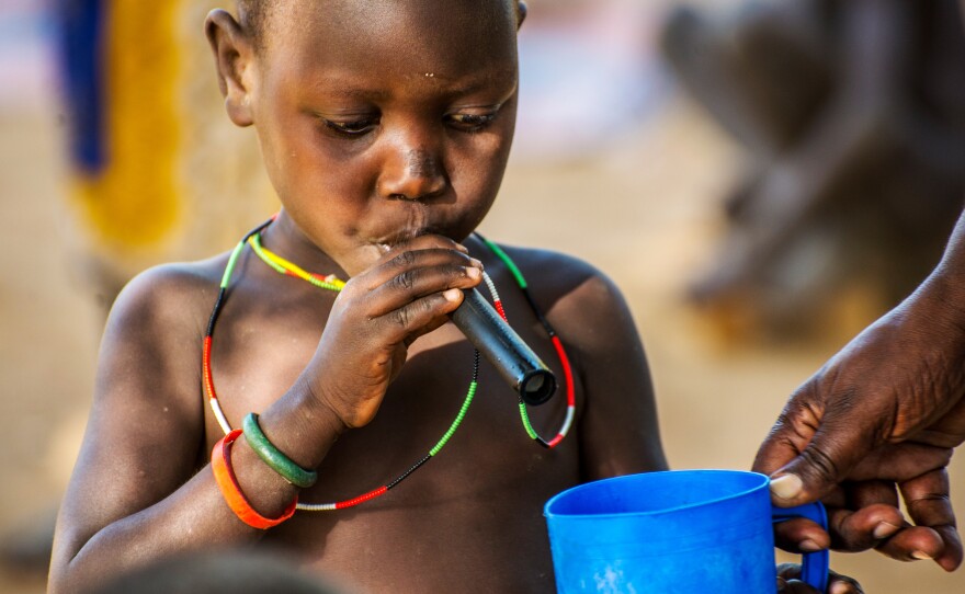 A kid learns that drinking water through a filtered straw can prevent Guinea worm. Twelve of the 17 Guinea worm cases in 2014 have occurred in South Sudan's Eastern Equatoria State, where this child lives.