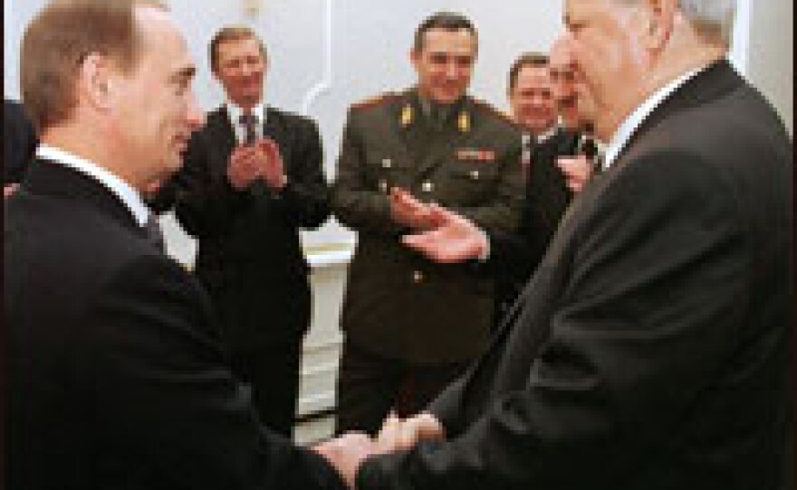 Outgoing Russian President Boris Yeltsin (right) shakes hands with Prime Minister Vladimir Putin during a farewell ceremony in the Kremlin on Dec. 31, 1999.