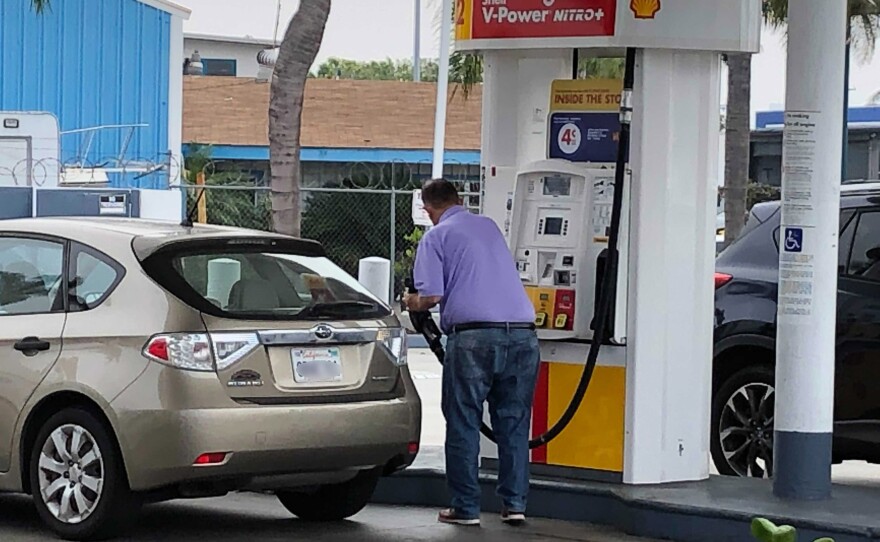 A man pumps gas at a Shell station in the Midway District of San Diego, Calif. Nov. 16, 2021.