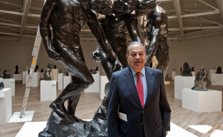 Carlos Slim invested more than $800 million in the Soumaya Museum, the second museum opened by the telecommunications mogul. Here, he stands with Auguste Rodin's <em>The Three Shades</em> on March 28, the eve of the opening.