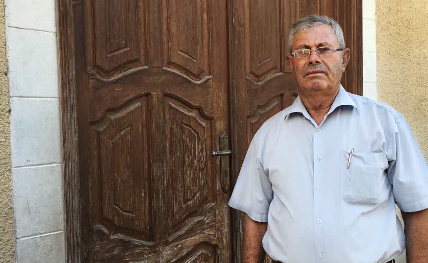 Mohammad Sultan stands outside the locked door of a children's clinic in Gaza City. Sultan ran the clinic for World Vision, which temporarily closed the center after its Gaza director was accused of diverting humanitarian assistance to Hamas.