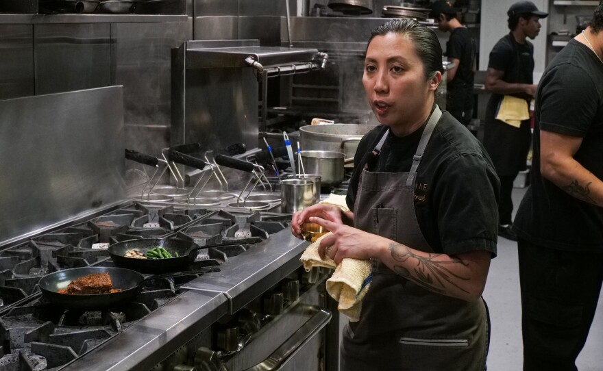 Tara Monsod, executive chef of Animae, stands near a stove in the kitchen. San Diego, Calif. April 11, 2024.