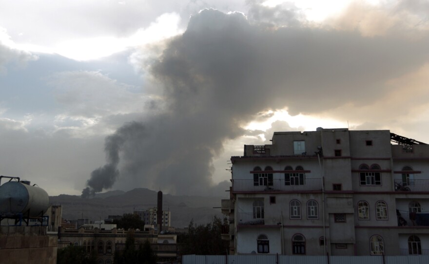 Smoke and flames reportedly from Shiite Houthi rebels camps rise over part of the Yemeni capital, Sanaa, on Monday. Fierce fighting has left people trapped, including U.S. citizens.