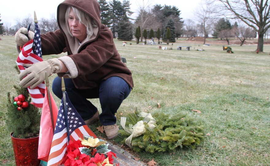 Anna Rodriguez tends the grave of her son, Nick. She learned shortly after Nick's death that, because his death was a suicide,