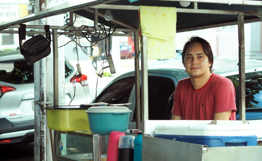 Bolsonaro supporter Theillor Cavalcante, 24, sells snacks from a cart outside a busy hospital by day and goes to accounting school at night. Among the reasons Calvacante cites for supporting Bolsonaro is that he believes he is uncorrupt and that he favors a more open economy and wider gun ownership. Calvacante says he's been a robbery victim four times in recent years.