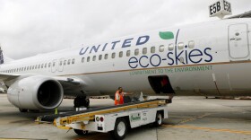 Employees load bags onto a Boeing 737-800 running on algae-based biofuel in Houston. Continental (owned by United Continental Holdings Inc.) flew the nation's first passenger jet powered by biofuels on Monday. 