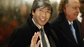 Pharmaceuticals billionaire Dr. Patrick Soon-Shiong waves as he arrives in the lobby of Trump Tower in New York for a meeting with President-elect Donald Trump, Jan. 10, 2017. 