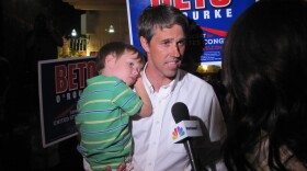 Beto O'Rourke holds his son while he speaks to local media at his election party in El Paso on Tuesday. O'Rourke won the Democratic nomination for the 16th Congressional District of Texas.