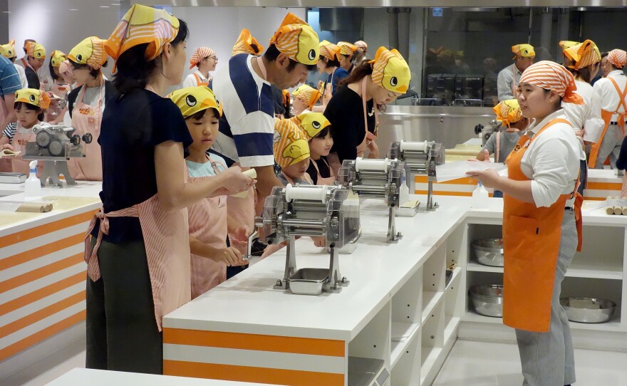 Visitors make their own noodles in the museum's working kitchen.