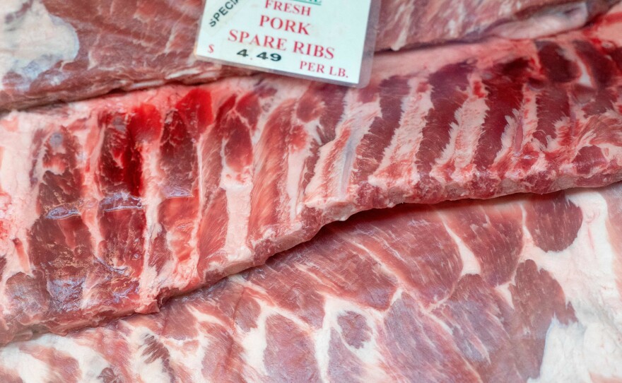 A price tag is displayed on pork spare ribs at Canales Quality Meats in Eastern Market in Washington, D.C, on Feb. 8. Rising food and fuel prices have been among the big drivers of inflation over the last year.