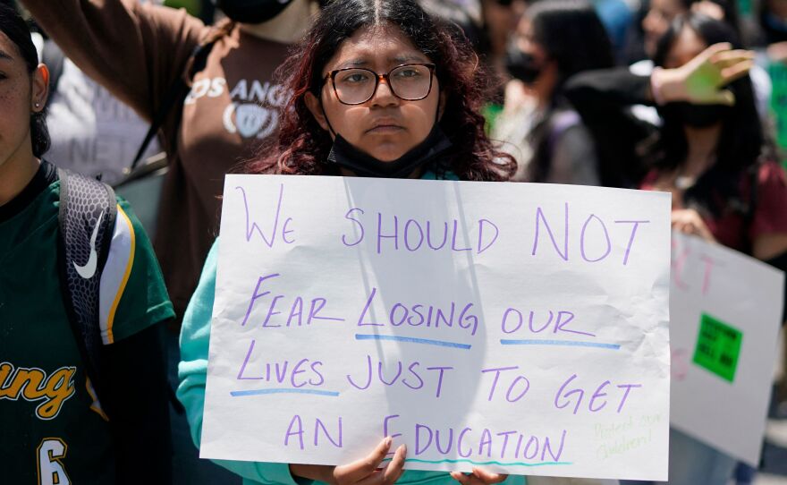 A young person holds a sign decrying gun violence at an abortion rights rally in Union Square in New York City on Thursday.