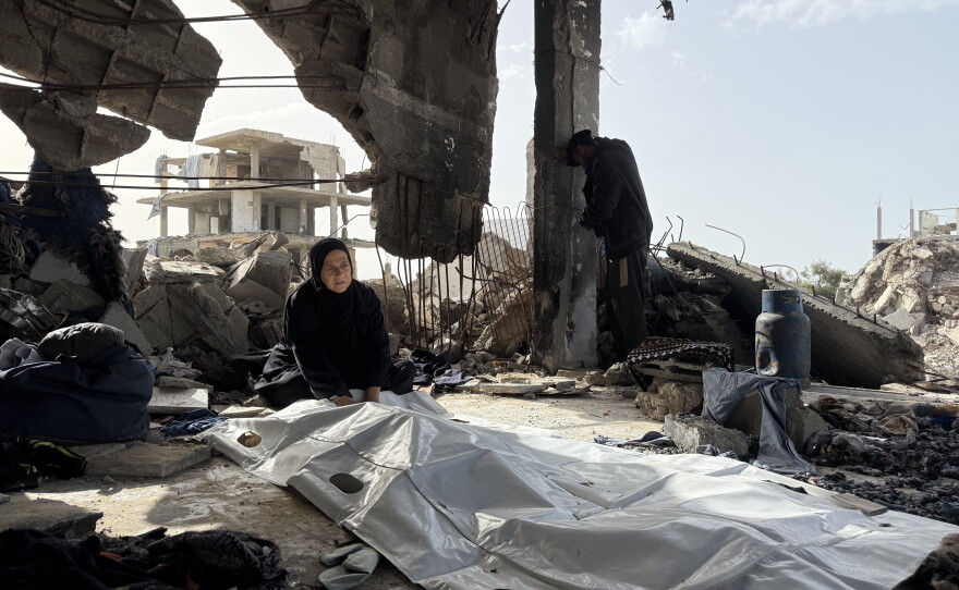 A mother from the Abu Nasr family sits by her son's body in Beit Lahia on Feb. 17, 2026. The body was retrieved from under the rubble more than a year after 132 people were killed in a single Israeli airstrike on the family home.
