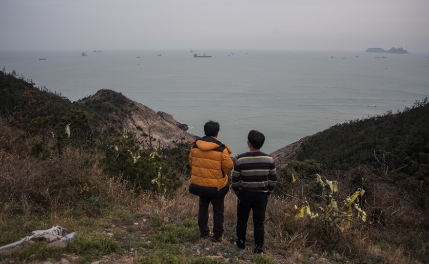 Relatives of victims of the Sewol ferry disaster observe efforts to raise the sunken vessel from a vantage point on the southern island of Donggeochado, South Korea.