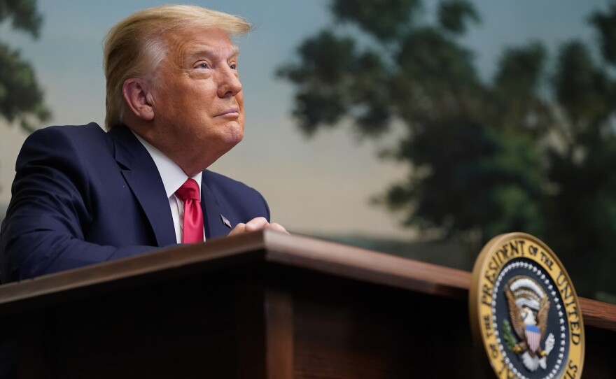 President Trump participates in a video teleconference call with members of the military on Thanksgiving at the White House.