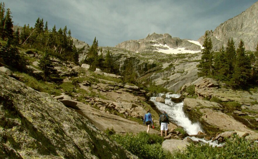 Rocky Mountain National Park. People hiking near a waterfall.